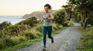 A professional, editorial-style photograph of an athletic person monitoring their heart rate on a sm